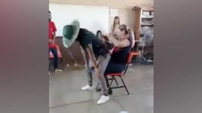 En las imágenes se puede ver a la maestra sentada en un pupitre mientras varios de los estudiantes se contonean frente a ella. Foto: Especial/ captura de pantalla