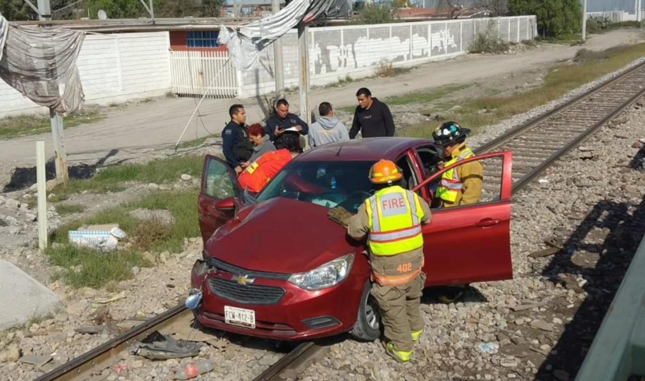 Automóvil arrastrado  por el tren.